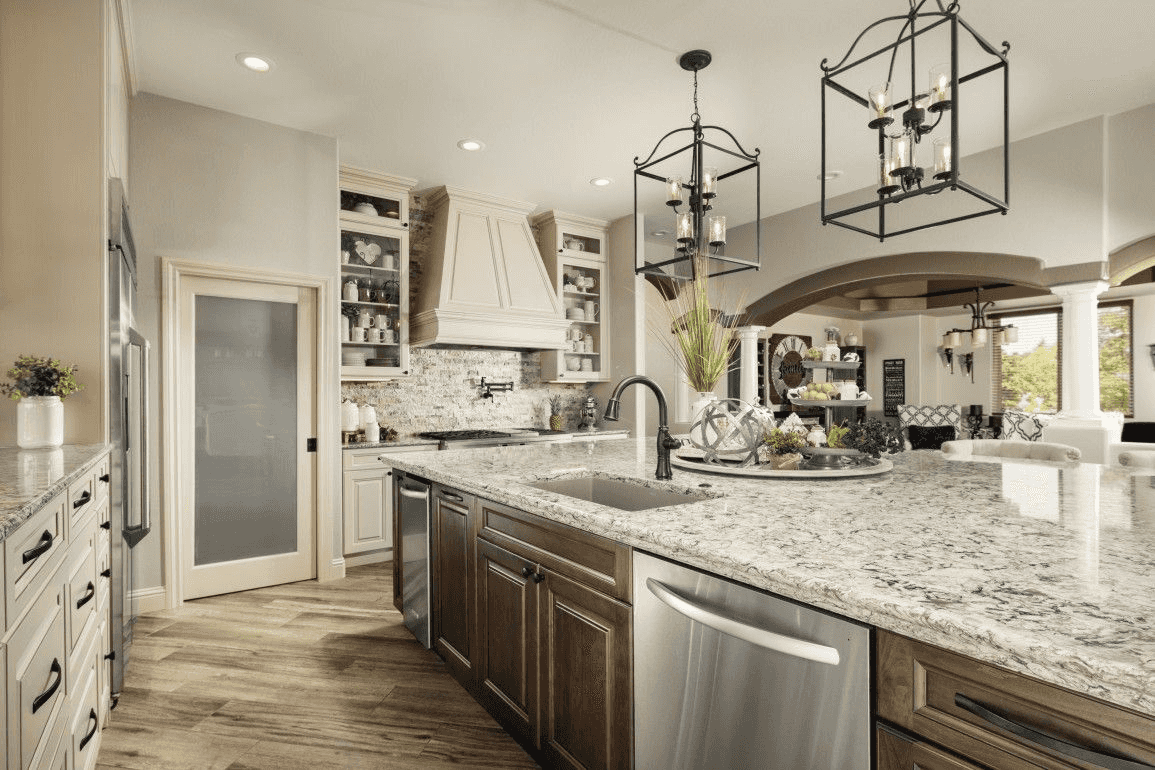 traditional kitchen with white and brown cabinets and marble countertops