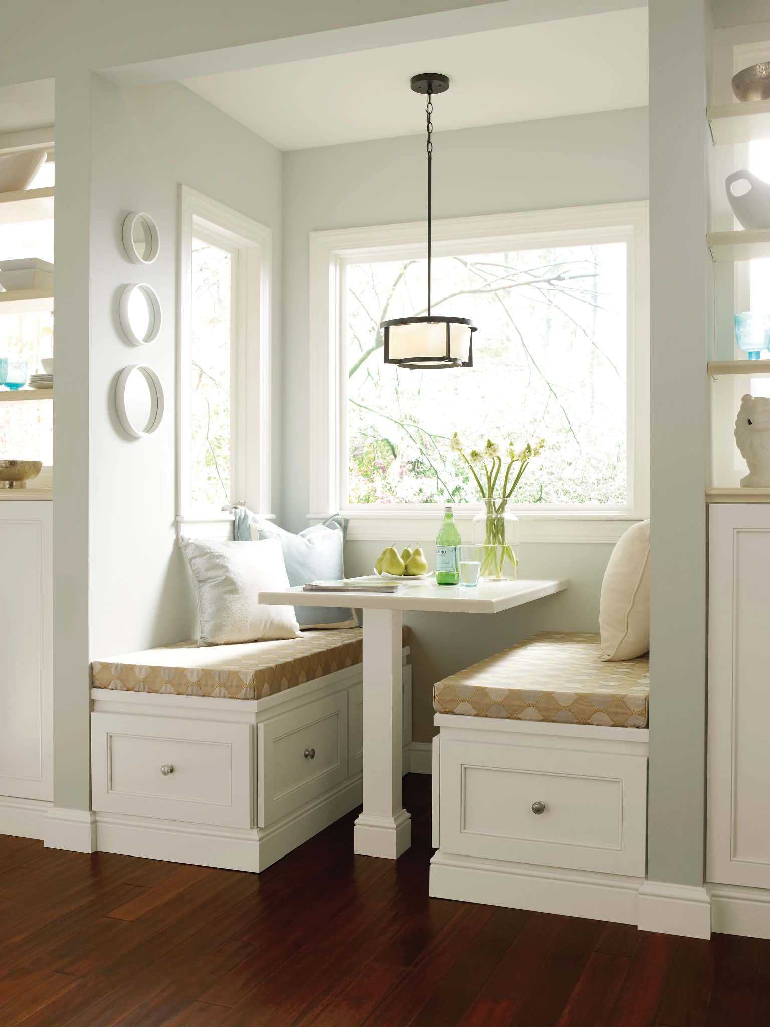 kitchen nook with built-in white cabinets beneath bench seats